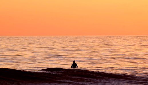 silhouette of person in body of water photo