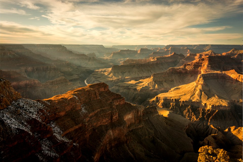 grand canyon below cloudy sky