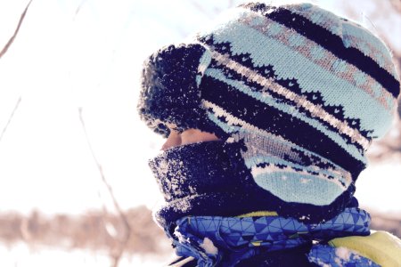 person wearing black and teal striped hat at snowtime