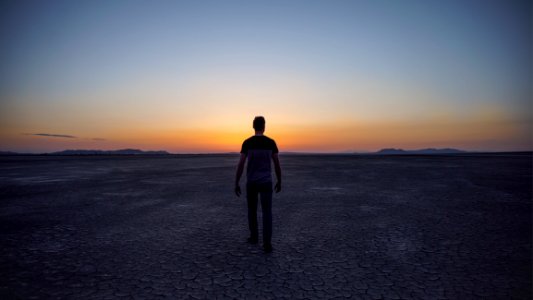 man walking on desert