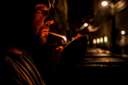 man lighting up flip-top lighter for cigar photo