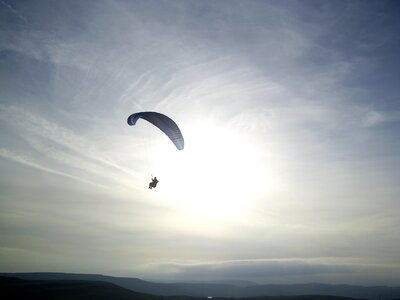 Paragliding flying sunset