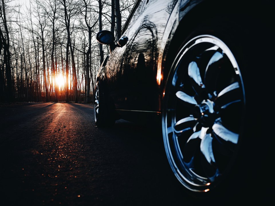 black car in the middle of the road during nightfall