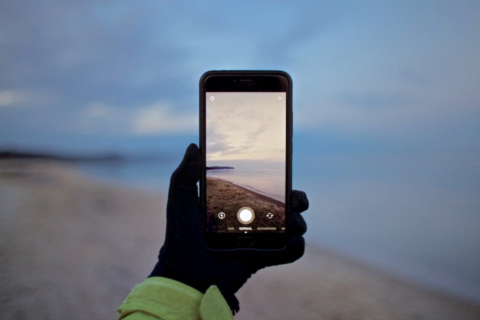 person black smartphone taking picture