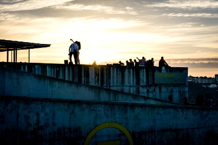 people walking on gray concrete bridge during daytime photo