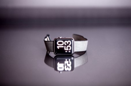 silver titanium Apple Watch with gray nylon strap photo