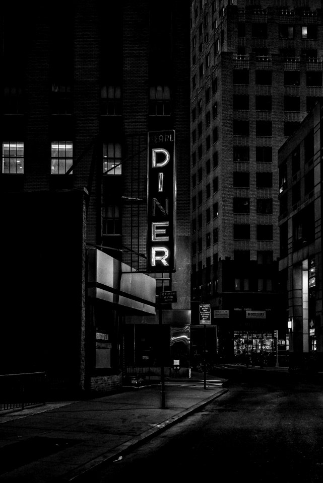 grayscale photo of Pearl Diner sign in city