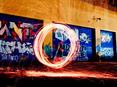 time-lapse photography of woman using steel wool photo