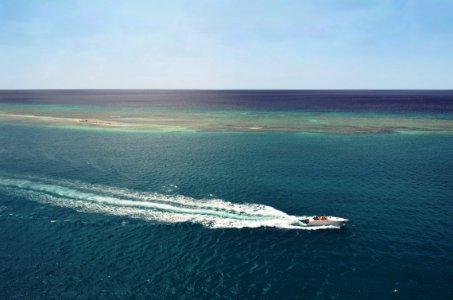 white speedboat running in middle of ocean during daytime photo