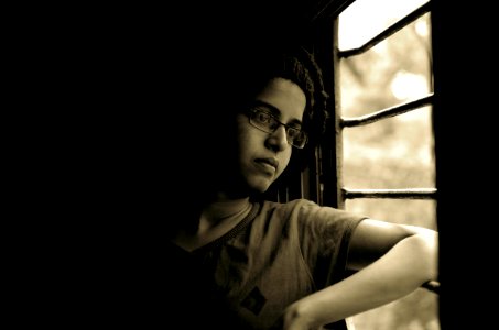 woman looking out through window photo