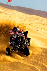 person riding on ATV and drift on sand photo