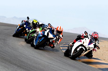 group of people riding sports motorcycles photo