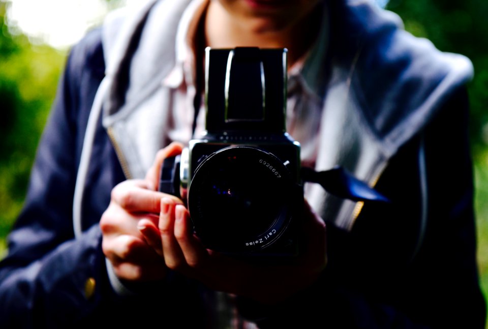 person holding black DSLR camera