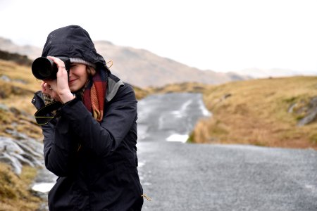 photo of woman taking pictures photo