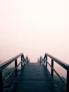 black wooden stairway covered with fog