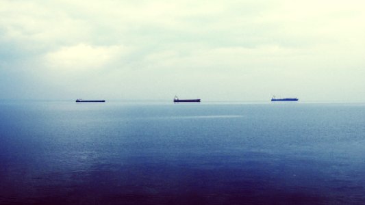 three ship on calm body of water photo