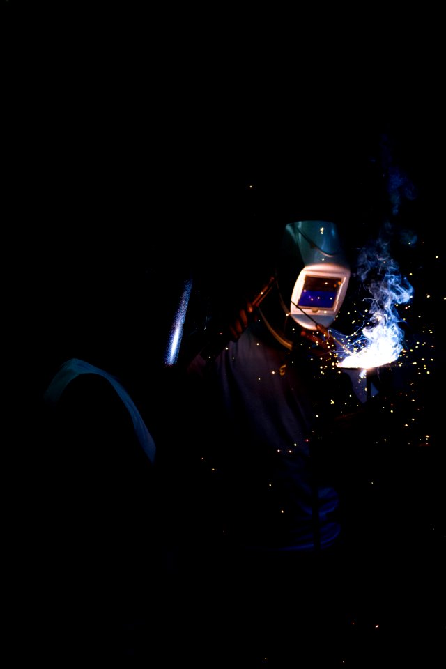man welding and wearing mask