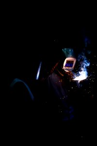 man welding and wearing mask