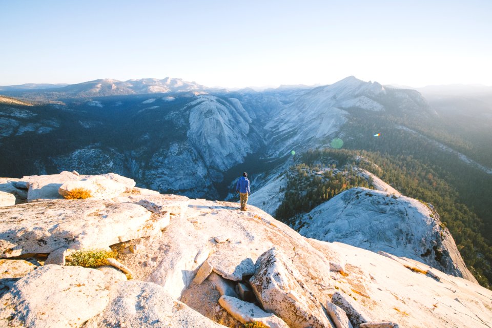 person standing on mountain during daytime photo