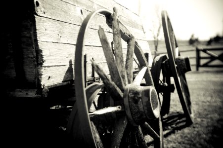 grayscale photo of wagon wheel photo
