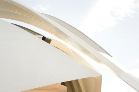 A long arch at the edge of a modern white facade