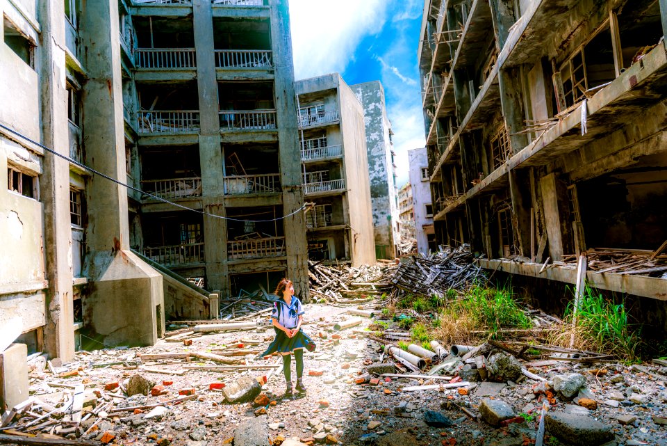 woman wearing white and green dress surrounded by storey buildings