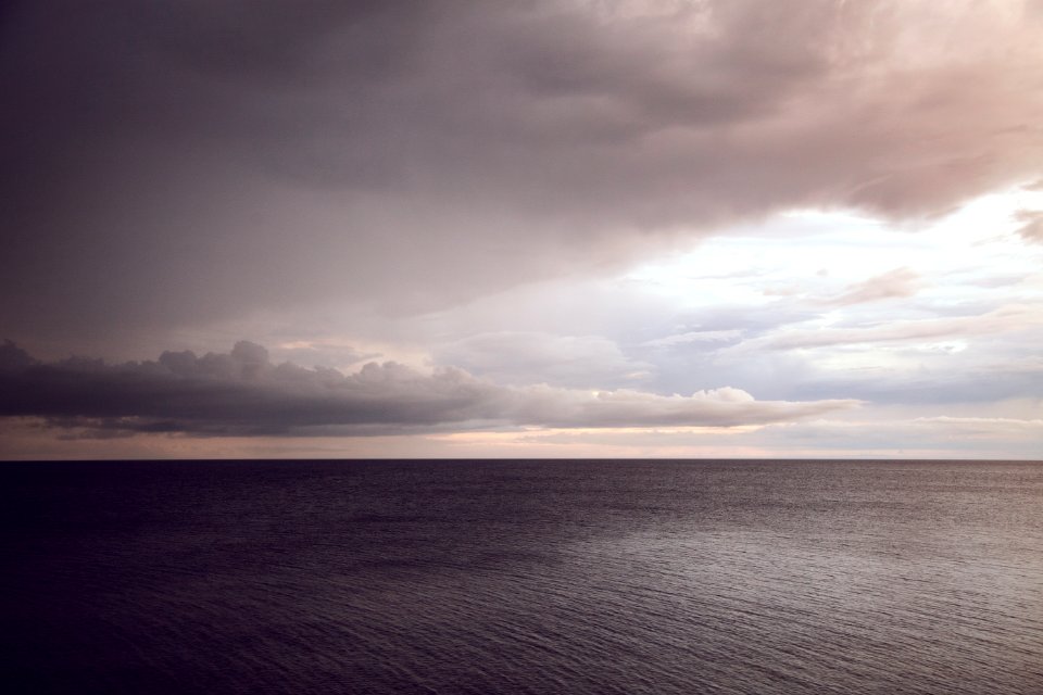 boy of water under comulus clouds