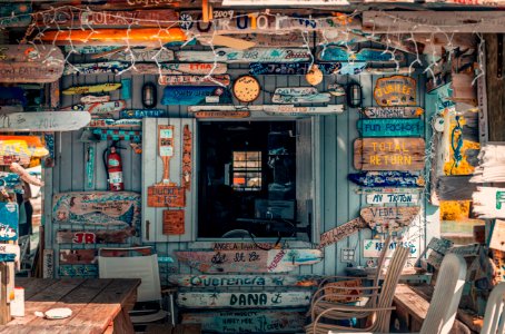 wooden house with assorted signage