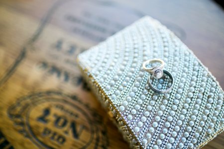 silver ring on white textile photo