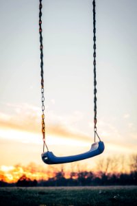 selective photography of blue plastic swing photo