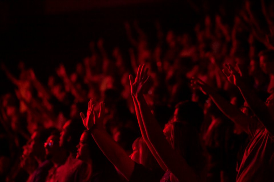 crowd lifting their hands watching concert photo