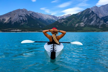 woman riding kayak at the middle of the sea photo