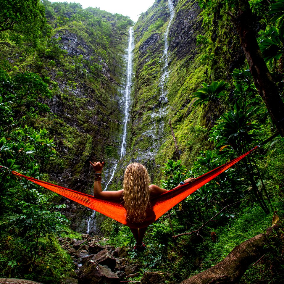 woman on hammock facing waterfalls