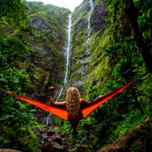 woman on hammock facing waterfalls photo