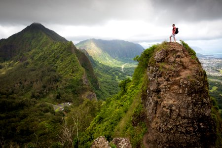 man on top of the mountain during daytime photo