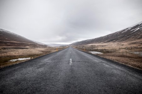 empty asphalt road through mountain photo