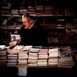 man holding book near library photo