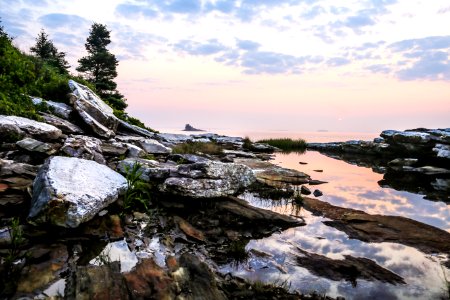 rock formation surrounded by water photo