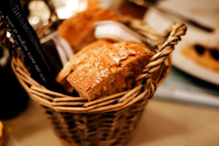 selective focus photography of baked bread on wicker basket photo