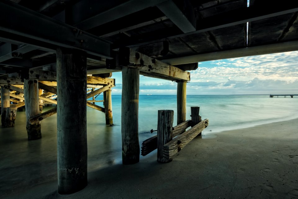 brown wooden footbridge under body of water