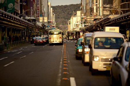 cars and bus stop in front of traffic lights