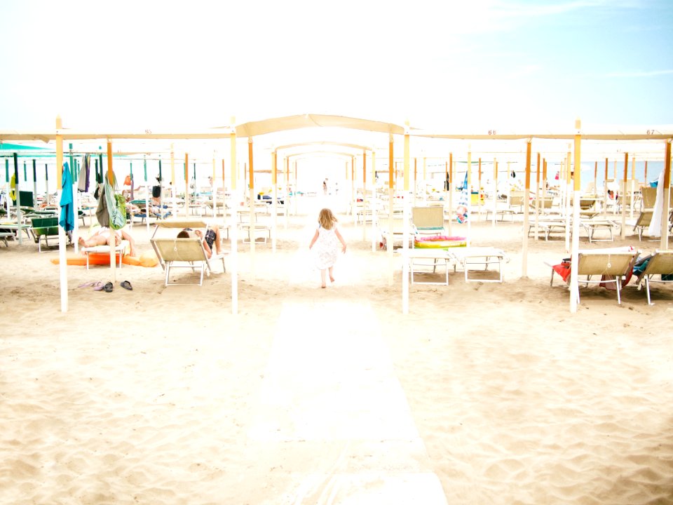 girl running towards beach photo