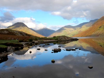 body of water surrounded with mountains photo