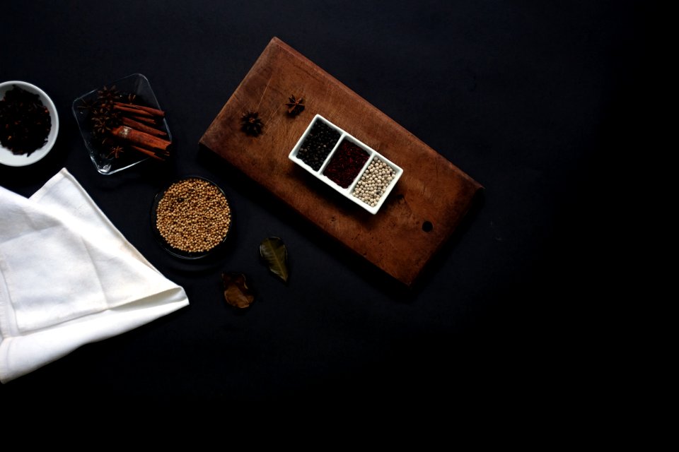 flat lay photography of beans on brown wooden board beside white handkerchief