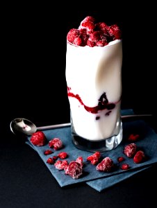 red raspberries on clear drinking glass photo