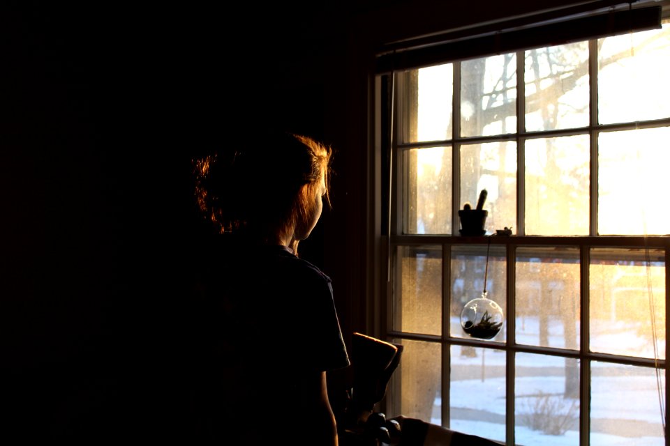woman in room facing window