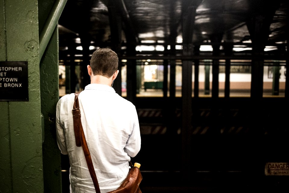 man wearing white dress shirt with crossbody bag