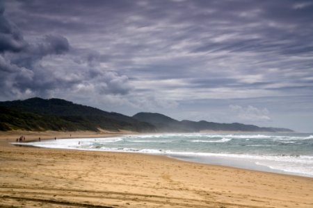 photo of people walking in seashore photo