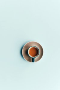 blue ceramic coffee cup and white saucer photo
