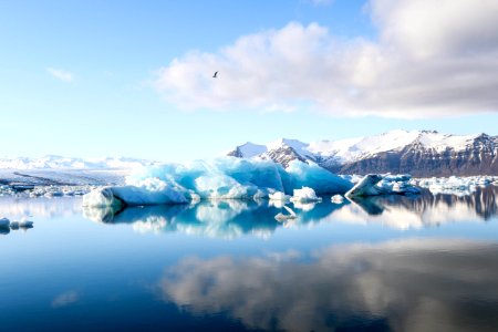 ice bergs and alp mountains facing calm body of water photo